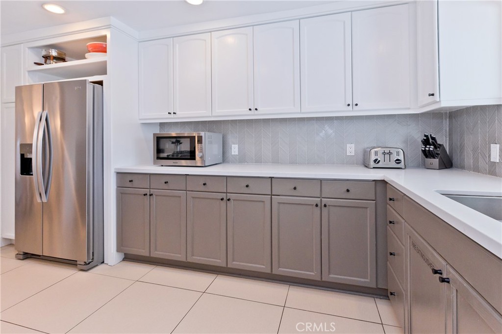 1057 East Marshall Way Palm Springs, CA 92262 - Photo 47 of 64 a kitchen with white cabinets and refrigerator