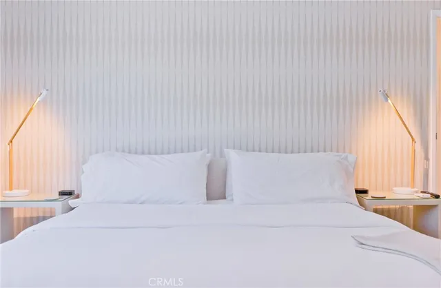 a front view of a house with fountain and potted plants
