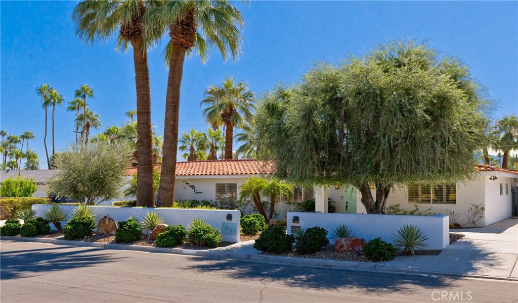 1057 East Marshall Way Palm Springs, CA 92262 - Photo 63 of 64 a front view of a house with fountain and potted plants