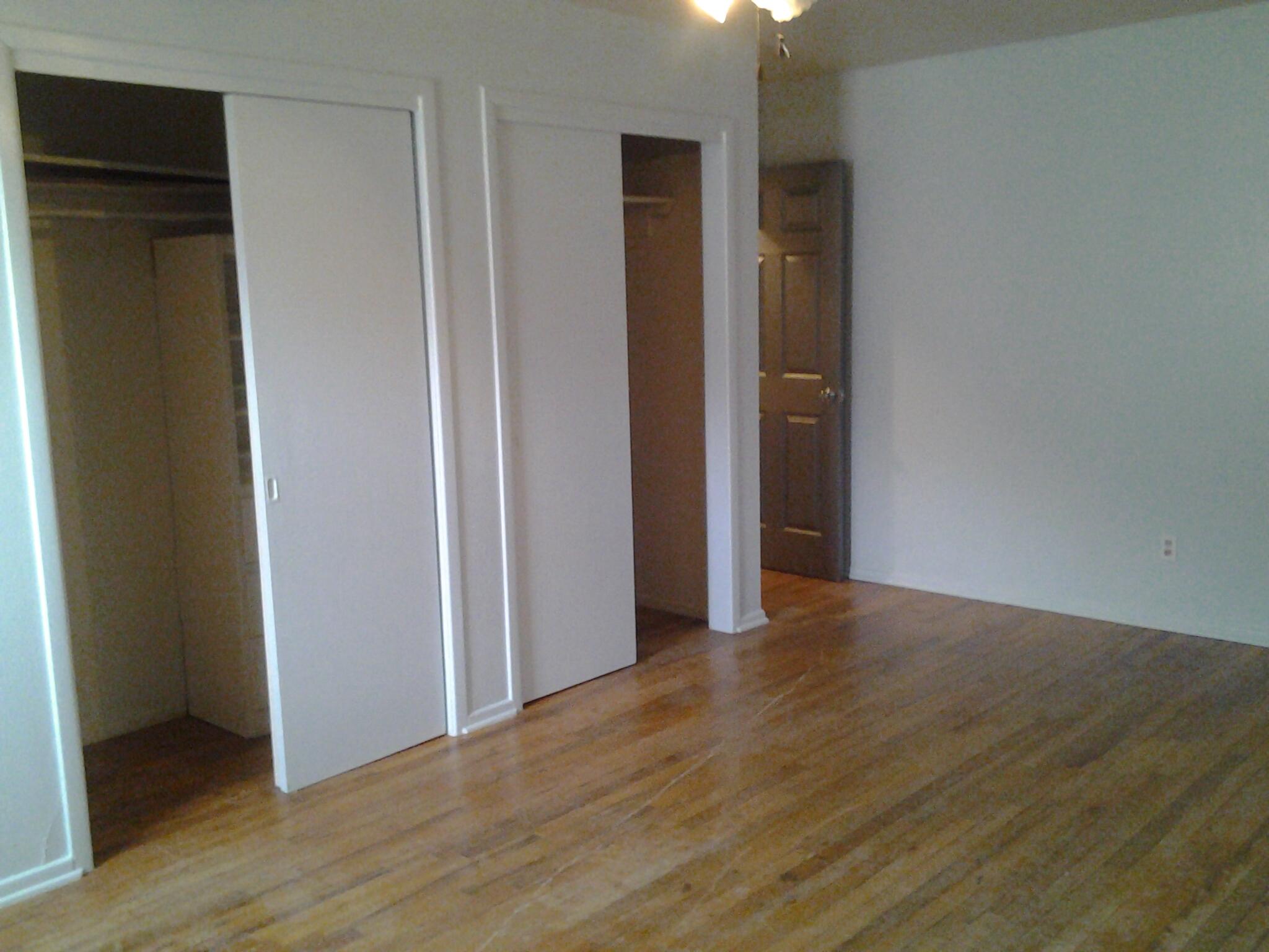 1404 South 9th Street Lamesa, TX 79331 - Photo 11 of 15 a view of an empty room with wooden floor and closet