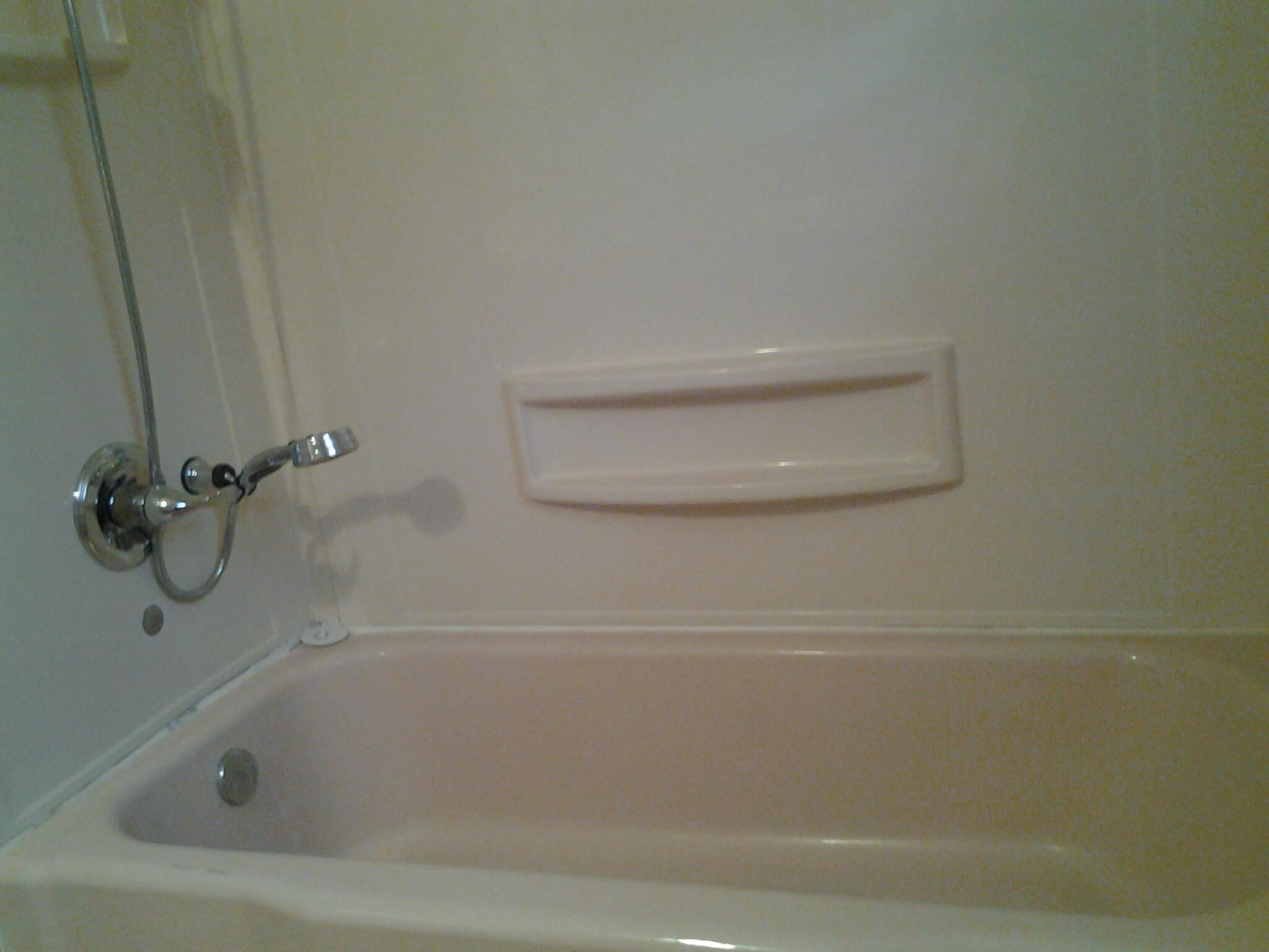 1404 South 9th Street Lamesa, TX 79331 - Photo 9 of 15 a close view of a bathtub in bathroom