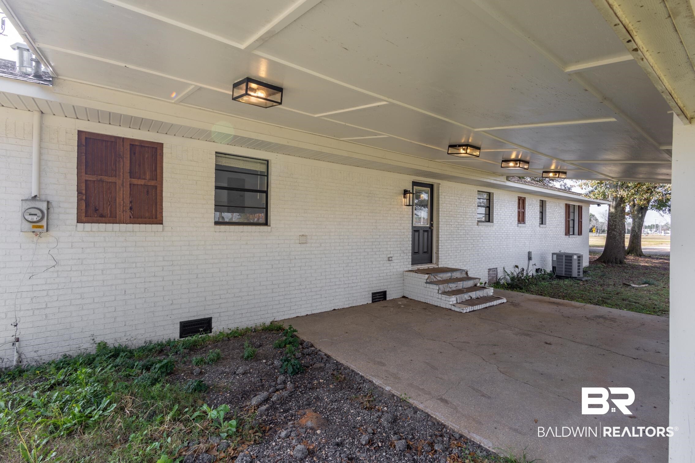 18267 Highway 98 Foley, AL 36535 - Photo 22 of 26 Entrance to property with crawl space, a patio area, and brick siding