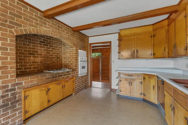 a bathroom with a granite countertop sink and a washing machine