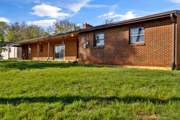 a view of a room with a table and chairs