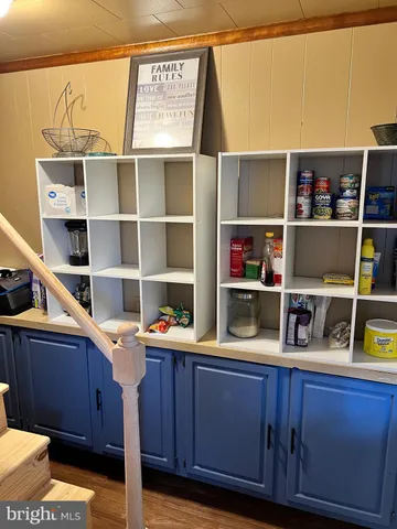 a room with a wooden floor and shelf