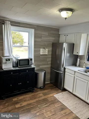a kitchen with a refrigerator and a sink
