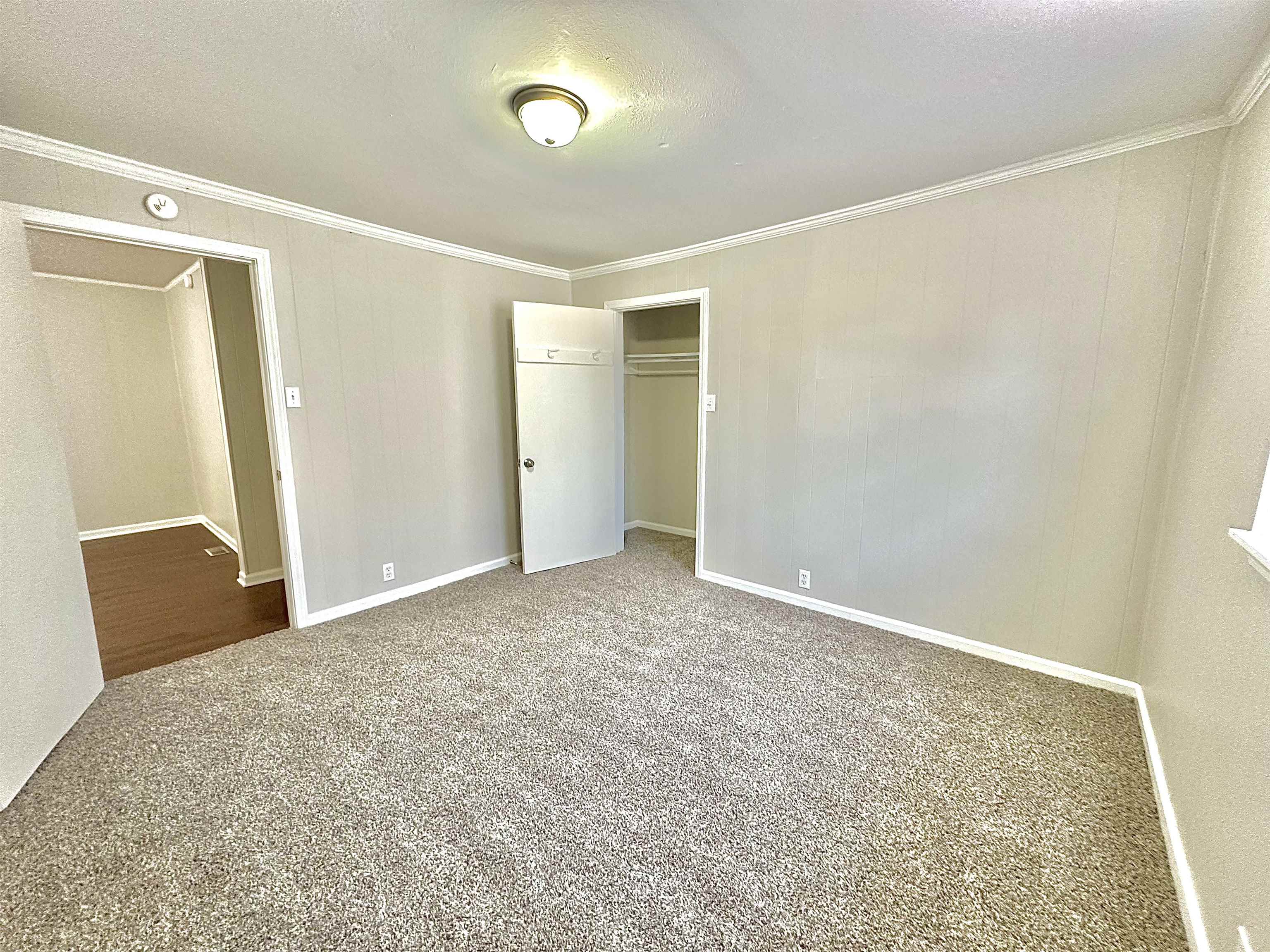 4346 Benjestown Road Memphis, TN 38127 - Photo 8 of 18 Unfurnished bedroom with crown molding, carpet flooring, baseboards, and a closet