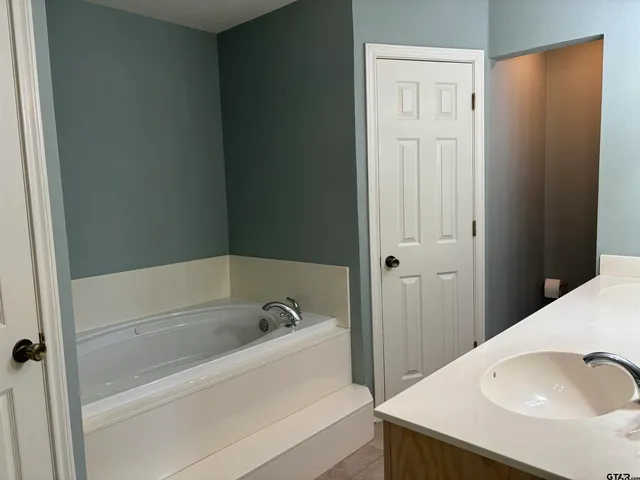 a view of kitchen with stainless steel appliances granite countertop a refrigerator and a sink