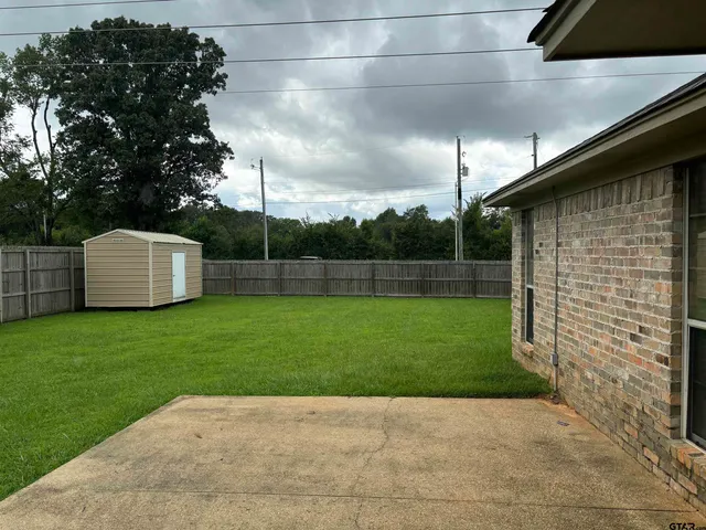 a view of a porch with furniture and a yard