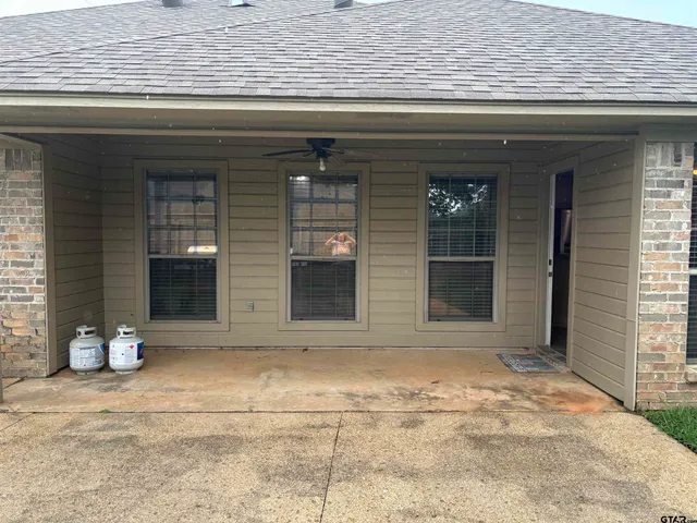 a backyard of a house with table and chairs