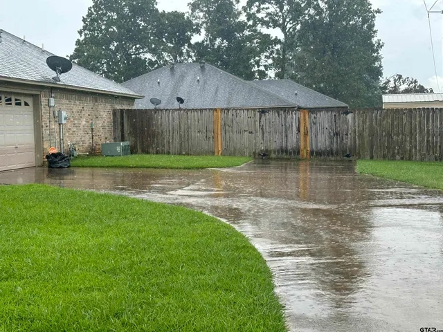 a view of a house with brick walls and a yard