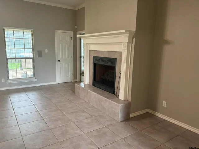 a view of a livingroom with an empty space and a fireplace