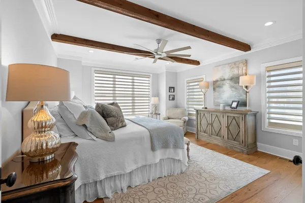 a bedroom with furniture and wooden floor