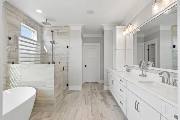 a bathroom with a double vanity sink toilet mirror and bathtub