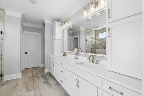 a bathroom with a double vanity sink and mirror