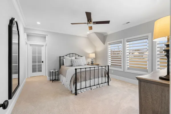 a bedroom with a bed next to a window