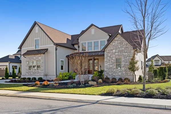 a front view of a house with a yard and garage