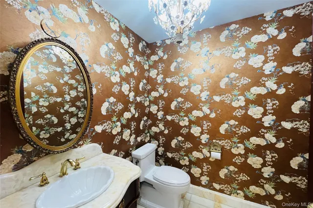 a bathroom with a toilet sink and mirror