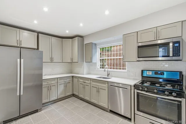 a kitchen with a sink stainless steel appliances and cabinets
