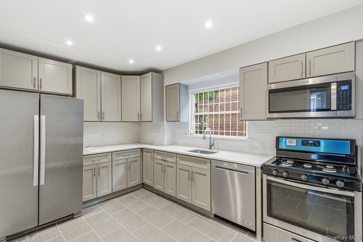 33-43 83rd Street Queens, NY 11372 - Photo 12 of 38 a kitchen with a sink stainless steel appliances and cabinets