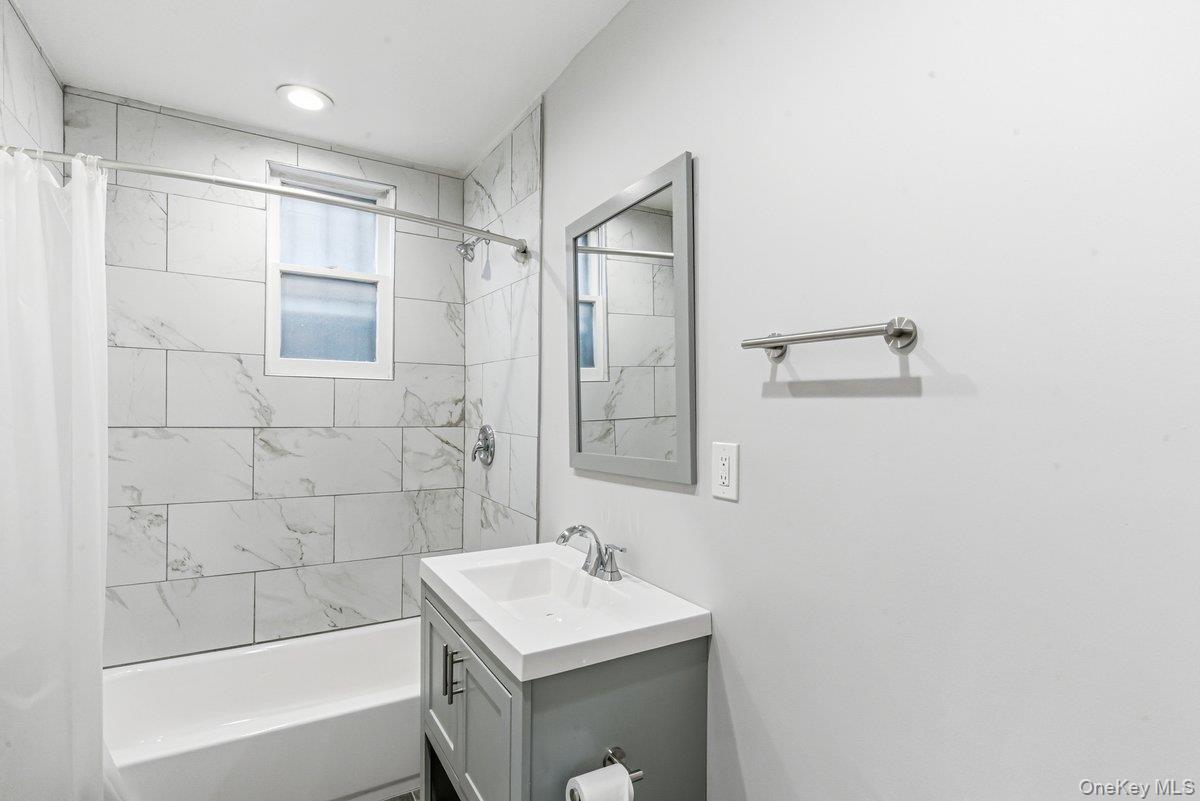 33-43 83rd Street Queens, NY 11372 - Photo 13 of 38 a bathroom with a sink mirror toilet and bathtub
