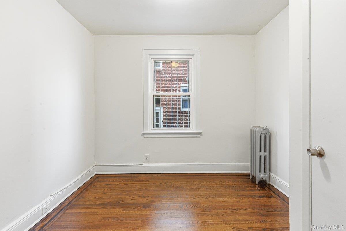 33-43 83rd Street Queens, NY 11372 - Photo 17 of 38 a view of an empty room with wooden floor and a window