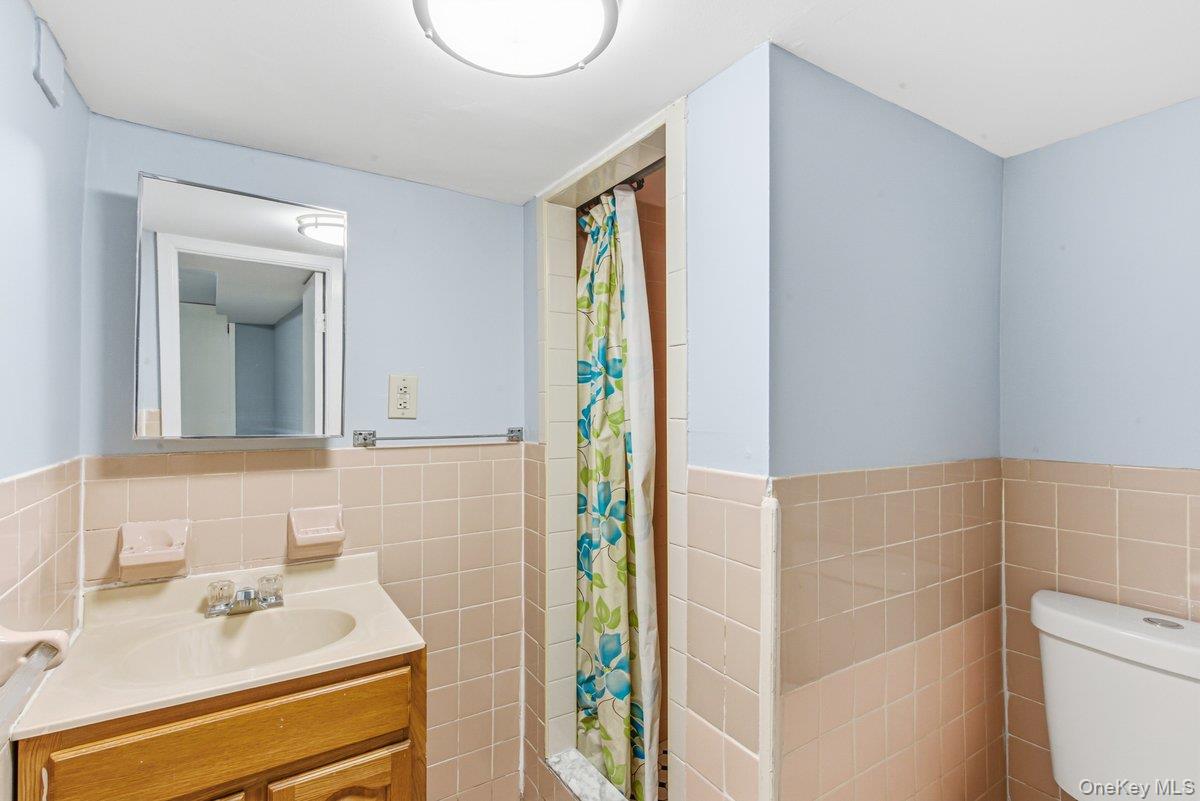 33-43 83rd Street Queens, NY 11372 - Photo 22 of 38 a bathroom with a sink a toilet and shower