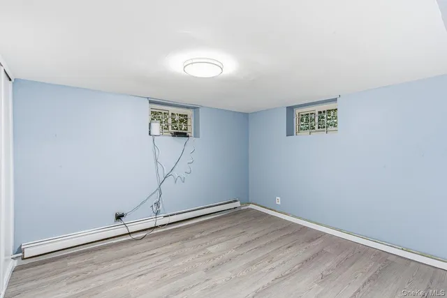 an empty room with wooden floor and painted walls