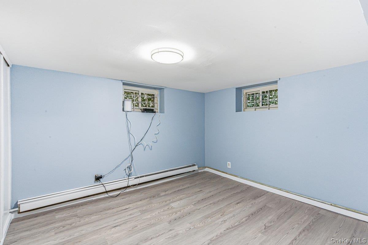 33-43 83rd Street Queens, NY 11372 - Photo 23 of 38 an empty room with wooden floor and painted walls