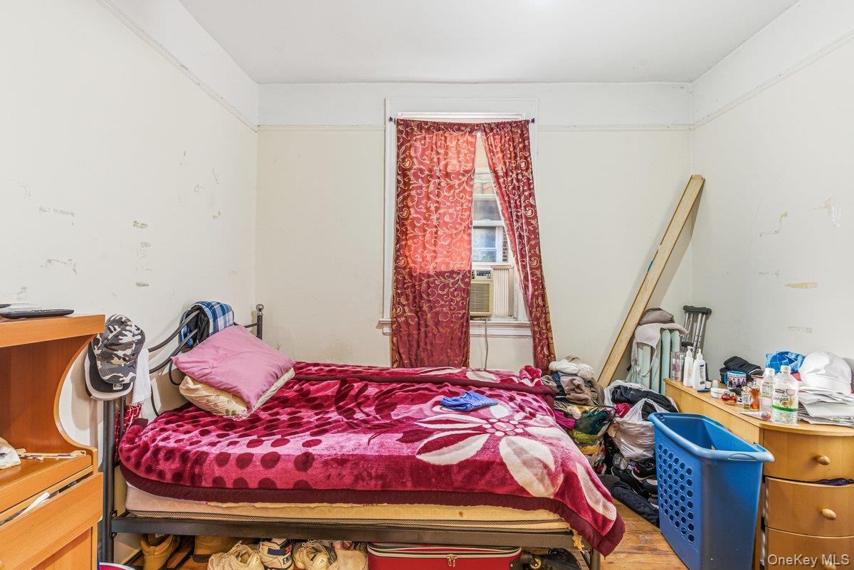 33-43 83rd Street Queens, NY 11372 - Photo 29 of 38 a bedroom with a bed and wooden floor