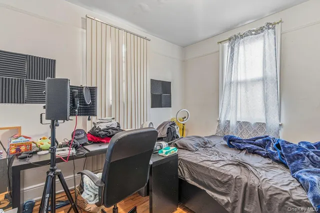 a bed room with a bed and two windows