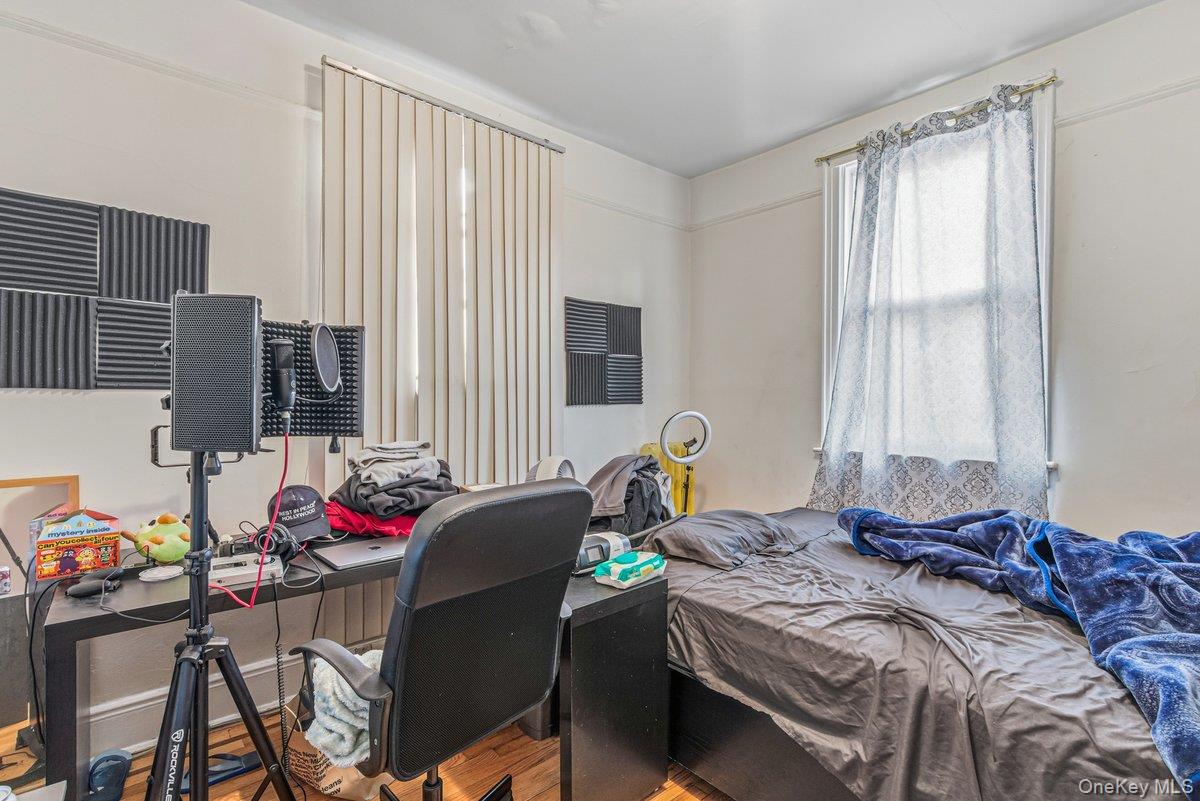 33-43 83rd Street Queens, NY 11372 - Photo 30 of 38 a bed room with a bed and a window