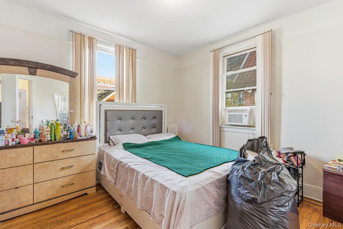 33-43 83rd Street Queens, NY 11372 - Photo 31 of 38 a bed room with a bed and two windows
