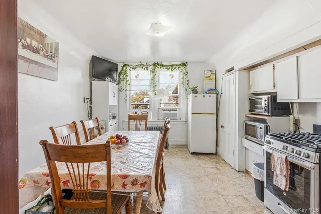 a kitchen with stainless steel appliances kitchen island granite countertop a refrigerator and a stove top oven