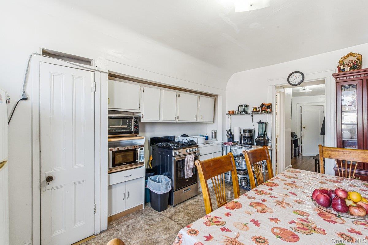 33-43 83rd Street Queens, NY 11372 - Photo 34 of 38 a kitchen with stainless steel appliances kitchen island granite countertop a refrigerator and a stove top oven