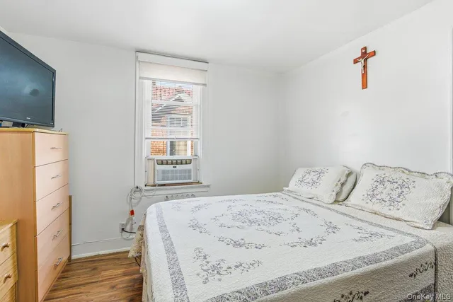 a bedroom with a bed and a book shelf