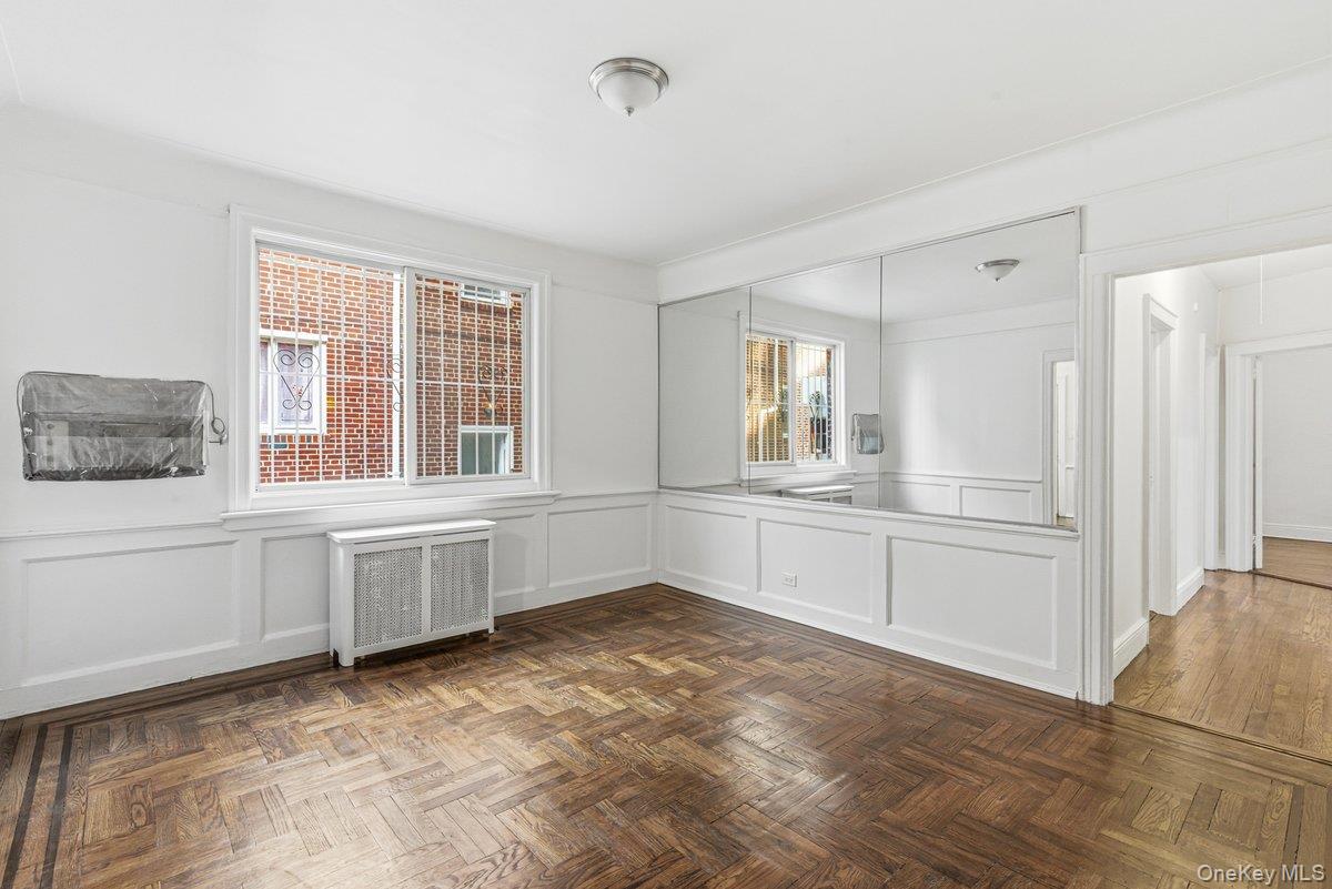 33-43 83rd Street Queens, NY 11372 - Photo 9 of 38 a view of an empty room with window and cabinet