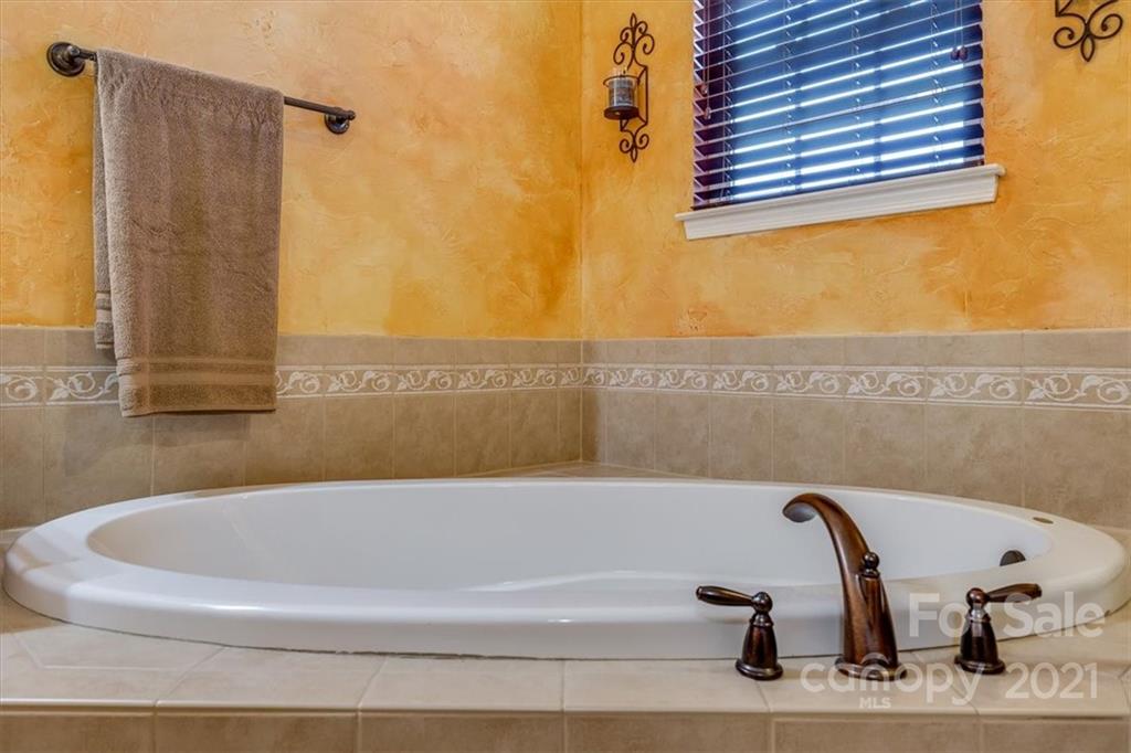 7178 Meyer Road Fort Mill, SC 29715 - Photo 32 of 36 a bathroom with a bathtub and a window