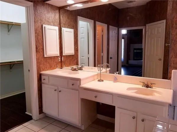 a bathroom with a double vanity sink and a mirror