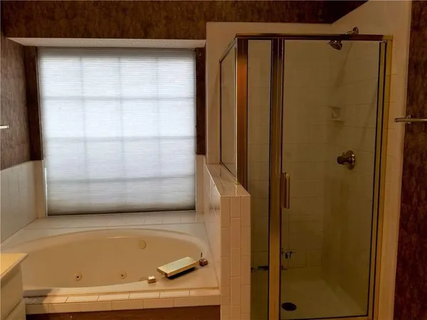 a bathroom with a tub and shower