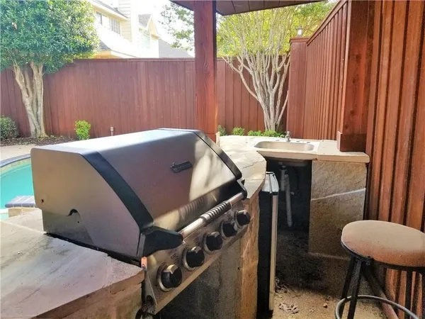 a view of a backyard with furniture and a cabin