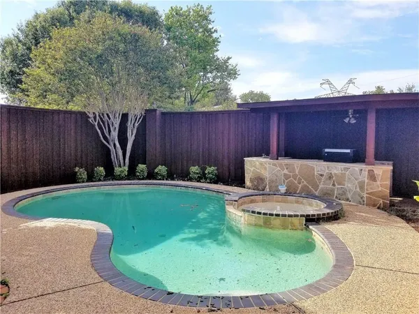 a view of a backyard with a small cabin and a chair