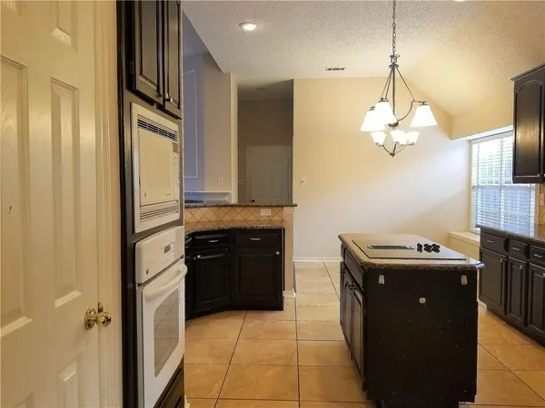 a kitchen with a refrigerator and a sink