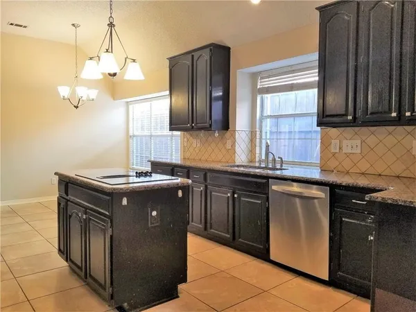 a kitchen with stainless steel appliances granite countertop a sink and a stove
