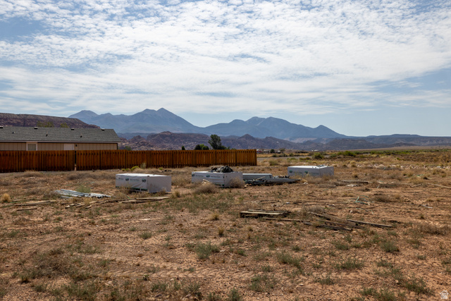 212 Lidia Circle, Unit 17 Moab, UT 84532 - Photo 21 of 24 Expansive desert landscape featuring distant mountains under a cloudy sky