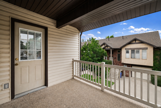 204 Lyman Lane Bountiful, UT 84010 - Photo 23 of 28 Private outdoor balcony featuring a textured concrete surface, white railing, and exterior wall with horizontal siding