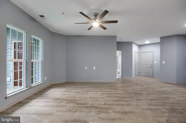 a view of an empty room with a ceiling fan