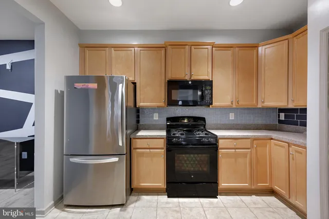 a kitchen with a refrigerator sink and stove