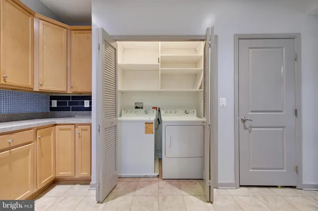 a view of a kitchen with refrigerator and cabinet
