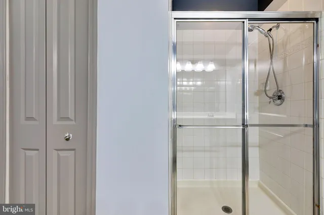 a bathroom with a glass shower door